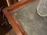a glass bottle sitting on top of a wooden table
