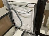 a white dishwasher sitting inside of a glass door