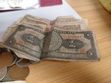 a pile of money sitting on a table next to a banana