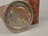 an old tin can that is sitting on a table