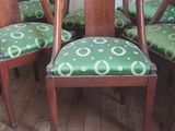 four chairs in a room with a rug on the floor