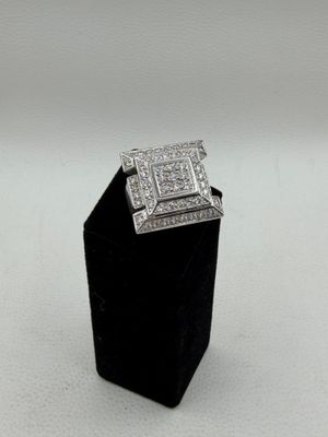 a close up of a diamond ring on a black stand