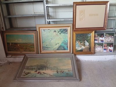 many framed pictures on the floor in a room