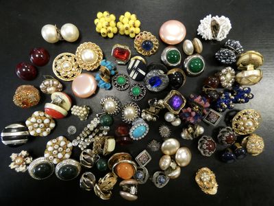 a close up of a pile of assorted jewelry on a table