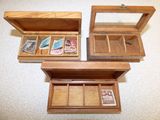 three wooden boxes that are open on the floor