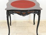 a small table with a red dot on the top of it