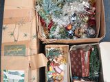 a box full of christmas ornaments and other items on the floor