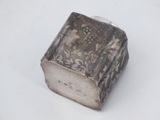 a silver box that is sitting on a white surface