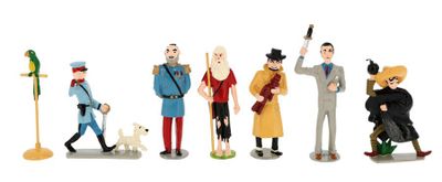 many figurines of different people and a dog on a white background