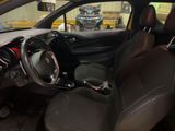 the interior of a small car with a steering wheel and dashboard