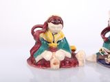two figurines of a woman and a cat on a table