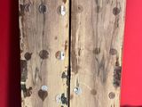 two wooden boards sitting on the floor next to a clock