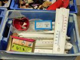 a blue container filled with assorted items and a thermometer