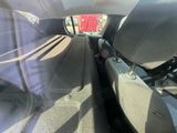 two seats in the back of a car with a red truck in the back