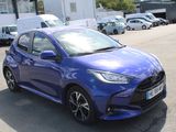 a blue toyota yaris parked in a parking lot