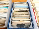 a lot of records in a box on the table