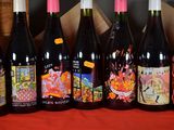 several bottles of wine are lined up on a table