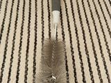 a small brush that is on top of a rug