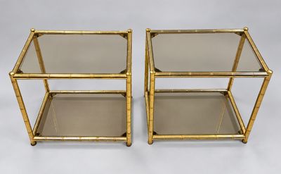 a pair of brass and glass side tables