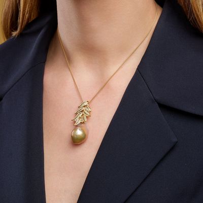 a woman wearing a black blazer and a gold necklace