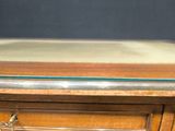 a wooden table with a glass top on it