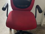 an office chair with a red seat and a black base