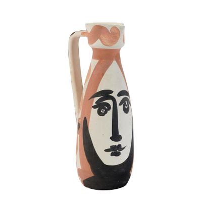 a vase with a face painted on the side of it