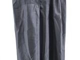 grey skirt hanging on a hanger against a white wall