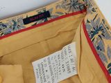 a label on the inside of a yellow purse