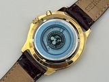 a close up of a watch on a white surface