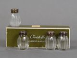 three glass salt and pepper shakers in a box on a table