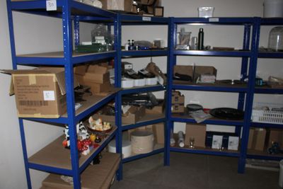 a blue shelving with lots of boxes and boxes on it