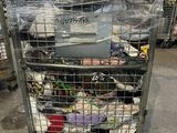 a metal cart with many items in it in a warehouse
