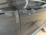 a close up of a car door handle with a sticker on it