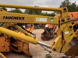a picture of a yellow machine that is in the dirt