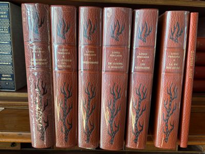 books on a shelf in a library with a lot of books on it