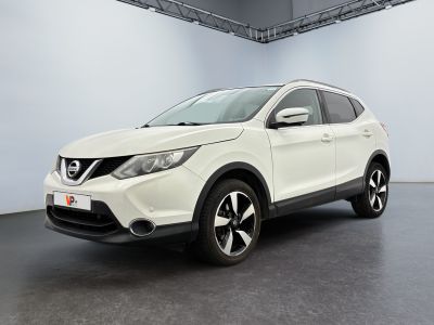 the white nissan qx - v is parked in a large room