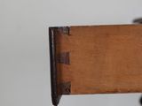 a close up of a wooden table with a drawer on it