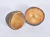 pair of brass acorns on a white background