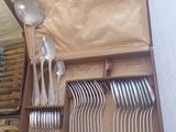 a lot of spoons and forks in a box