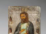 un tableau représentant un homme barbu tenant un livre dans la main droite
