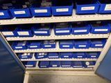blue bins are stacked on the shelves in a storage room