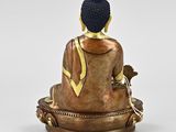 statue of a buddha sitting on top of a gold plate