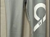 grey pants with white letters on them hanging on a hanger