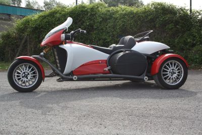 a red and white motorcycle parked in a parking lot