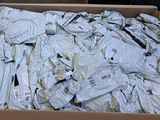 a cardboard box full of white shirts on a table