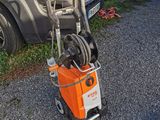 a small orange and white machine that is on the side of the road