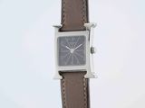 an image of a close up of a wrist watch with a brown strap