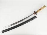 a close up of a samurai sword on a white surface