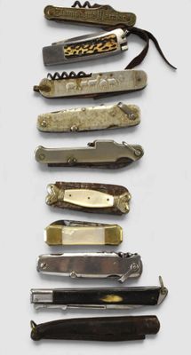 many different types of knives on a white surface
